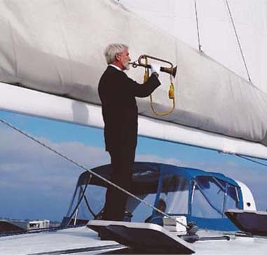 Man playing trumpet for a burial at sea procession