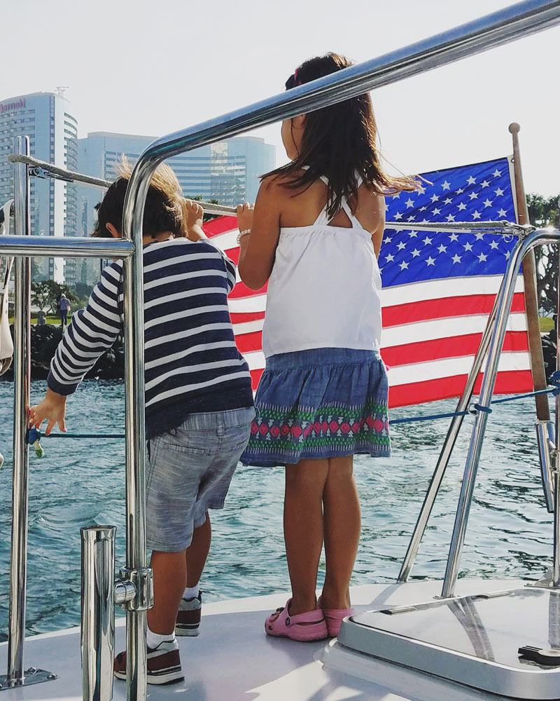 kids on a yacht celebrating fourth of july